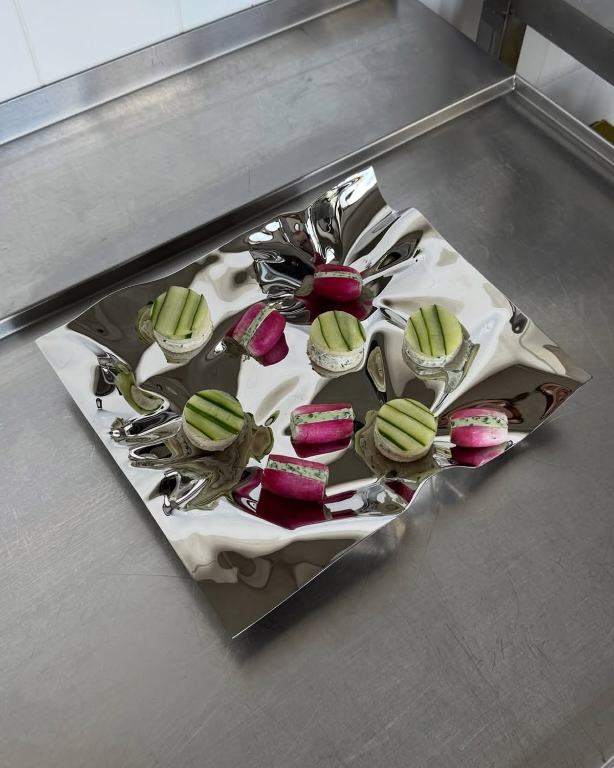 Small bites on a mirror tray — catering details